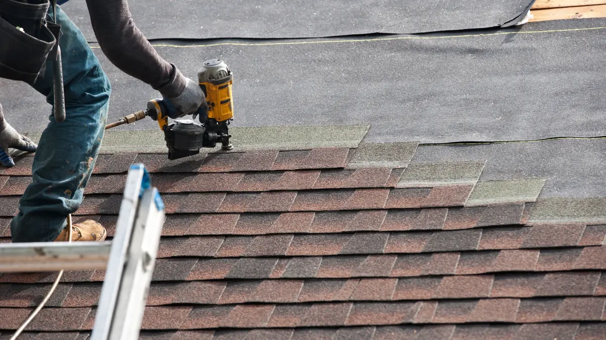 Owner Christian Chambers writing a written roof-repair estimate on-site.